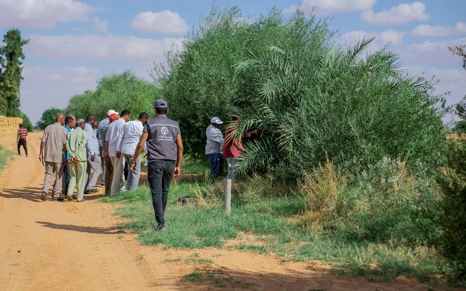 Agricultural field visit involving community members and technical specialists